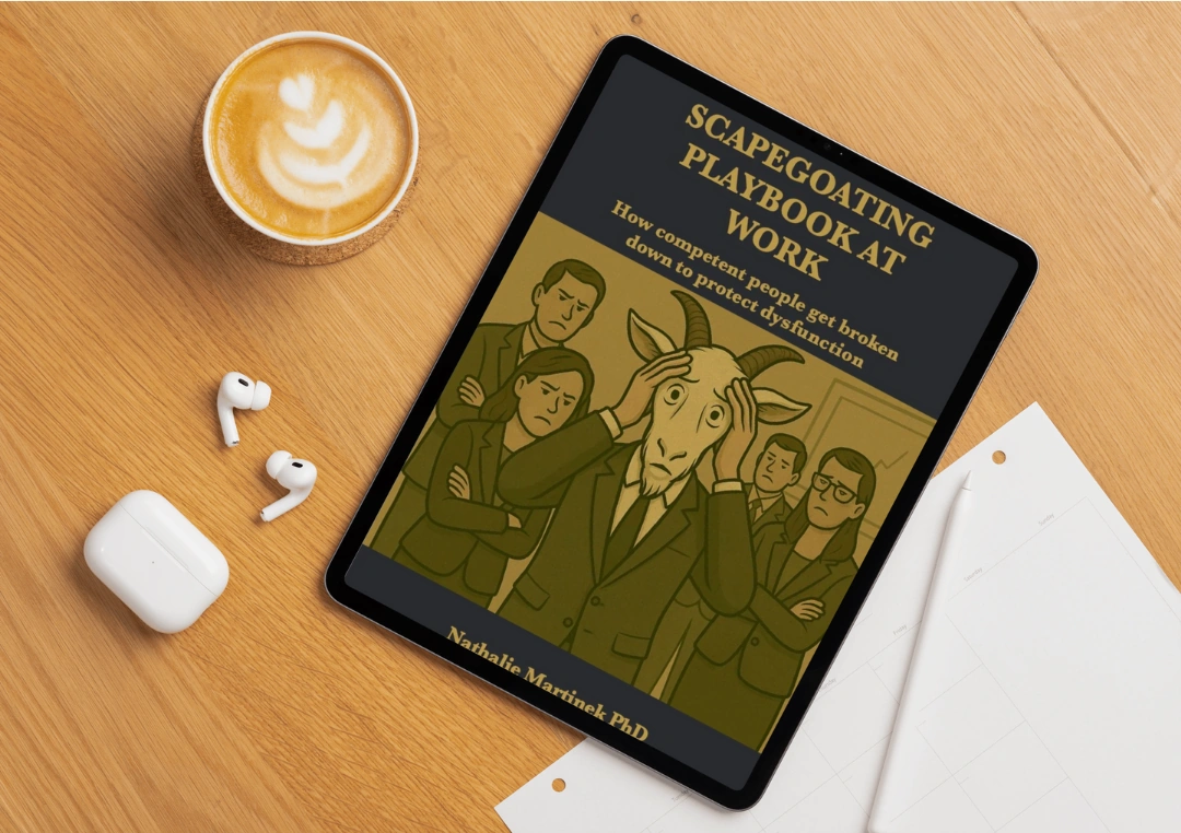 Scapegoating Playbook at Work — book cover by Nathalie Martinek PhD displayed on a tablet